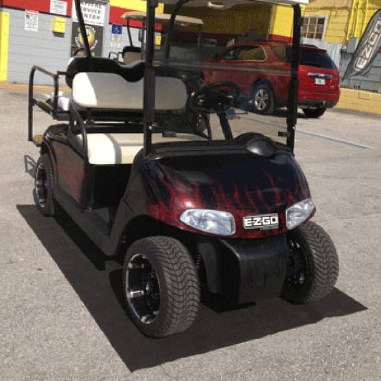 Golf cart parked on garage parking mat for easy access and protection.