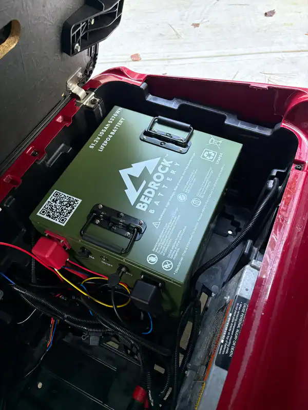 LiFePO4 battery installed inside red vehicle compartment